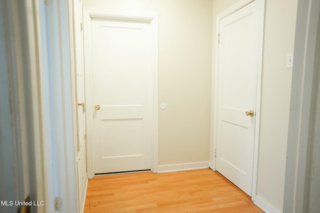 hall with light hardwood / wood-style floors