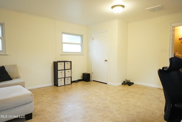 living area with crown molding