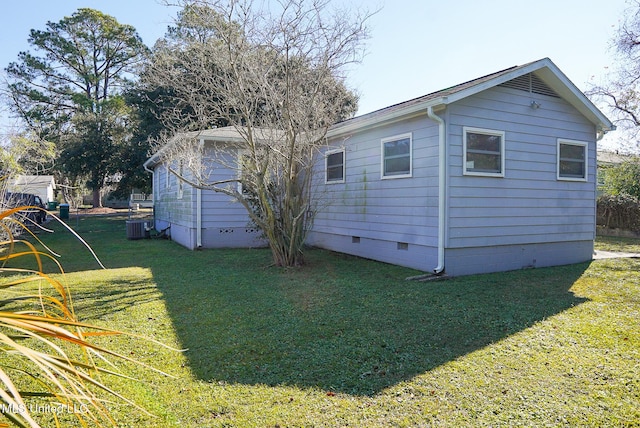 view of side of home featuring cooling unit and a lawn