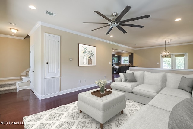 living room with crown molding, hardwood / wood-style floors, and ceiling fan with notable chandelier