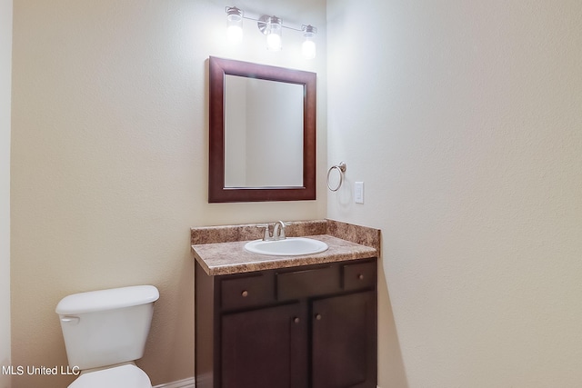 bathroom with toilet and vanity