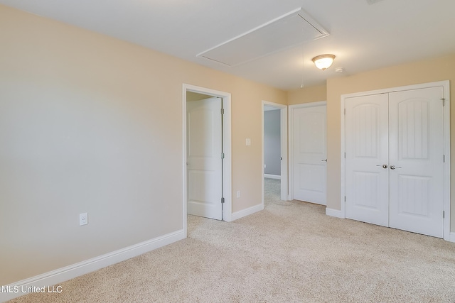 unfurnished bedroom with a closet and light carpet