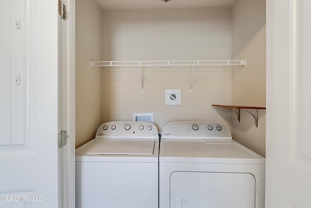 clothes washing area with washing machine and clothes dryer