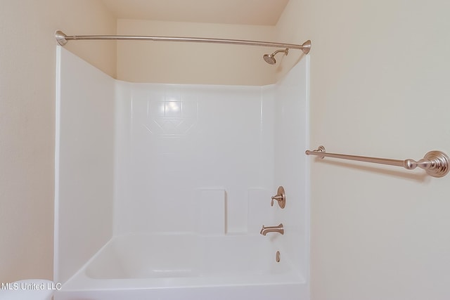 bathroom with bathing tub / shower combination