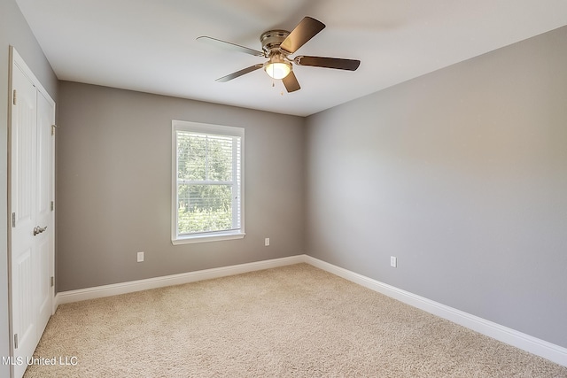 carpeted empty room with ceiling fan