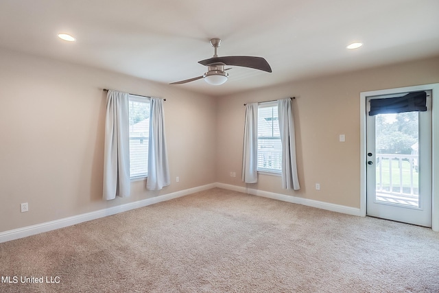 unfurnished room featuring ceiling fan and carpet floors