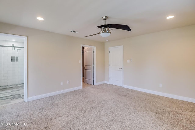 spare room with light carpet and ceiling fan