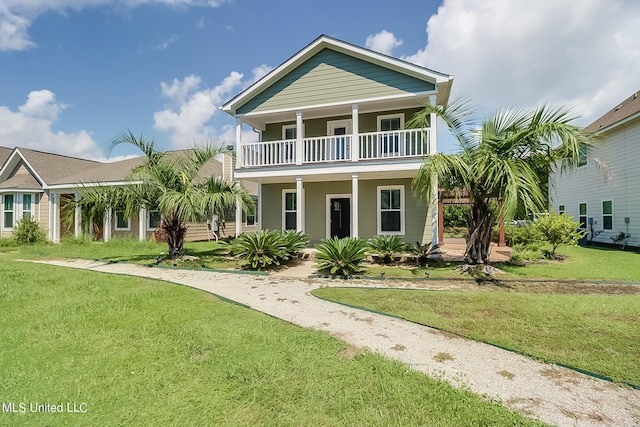 raised beach house with a balcony and a front yard