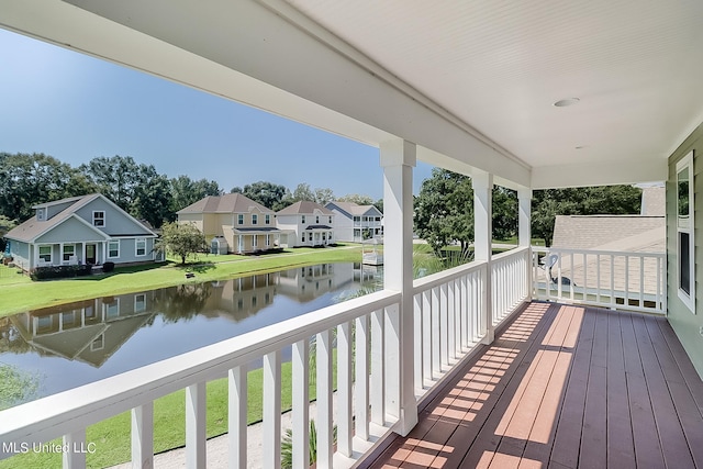 wooden terrace featuring a water view