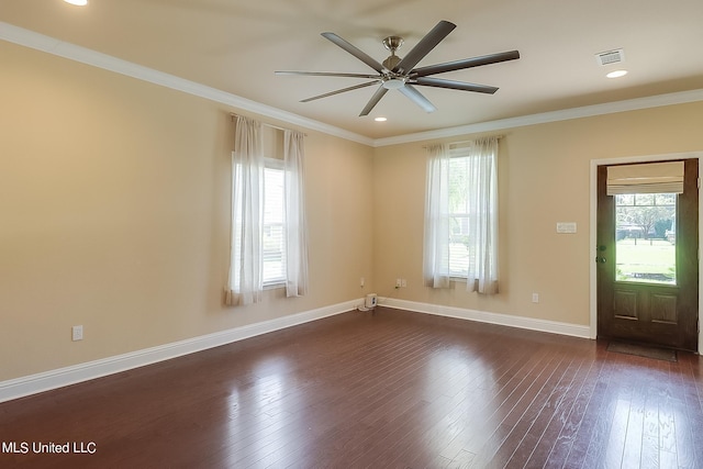 entrance foyer with a healthy amount of sunlight, ornamental molding, and dark hardwood / wood-style flooring