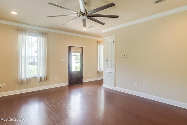 empty room with ceiling fan, ornamental molding, and dark hardwood / wood-style flooring