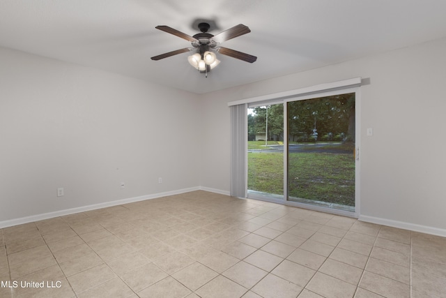 tiled empty room featuring ceiling fan