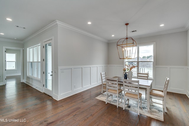 dining room with dark hardwood / wood-style flooring, a notable chandelier, and ornamental molding