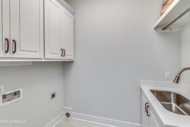 laundry area with electric dryer hookup, cabinets, sink, and hookup for a washing machine