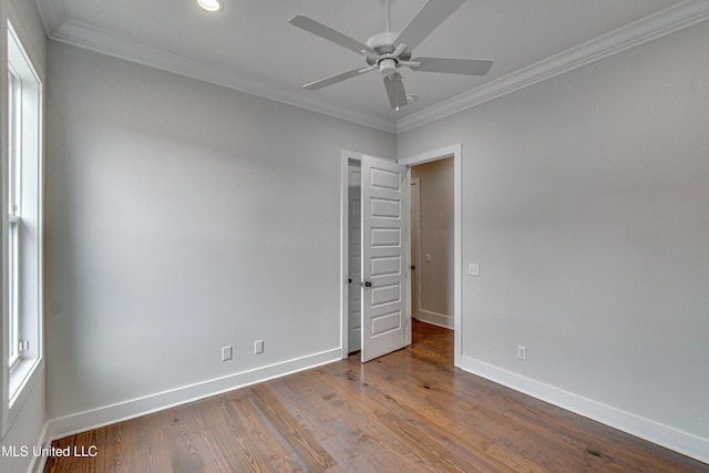 unfurnished room featuring ceiling fan, wood-type flooring, and ornamental molding