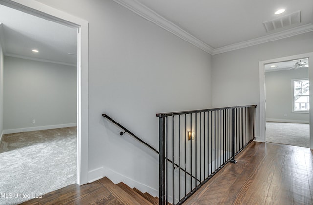 stairs with wood-type flooring and ornamental molding