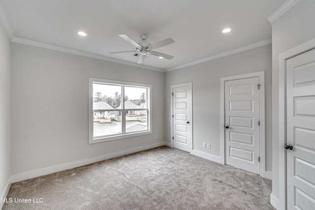 unfurnished bedroom featuring ceiling fan, light colored carpet, and ornamental molding