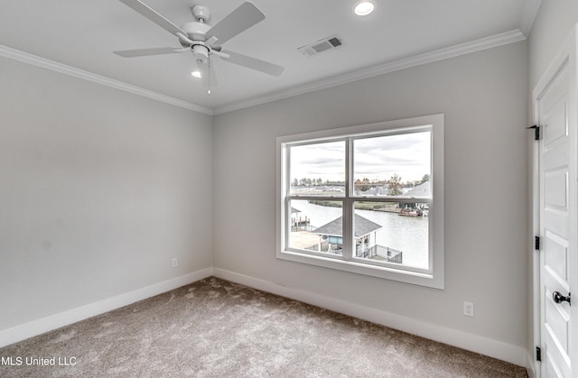 carpeted spare room featuring ceiling fan and ornamental molding