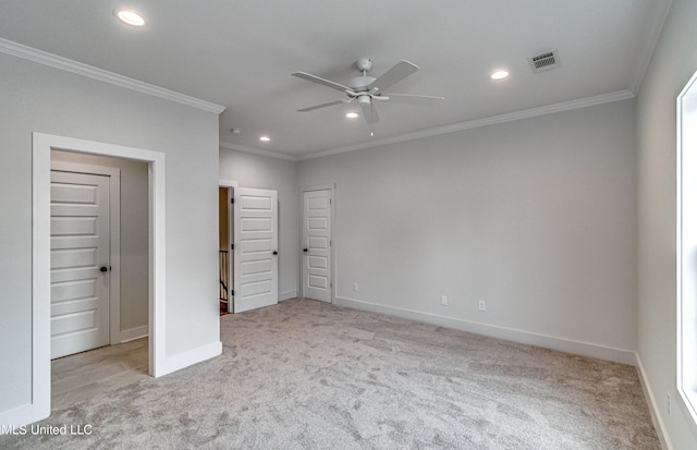 unfurnished bedroom featuring ceiling fan, crown molding, and light carpet