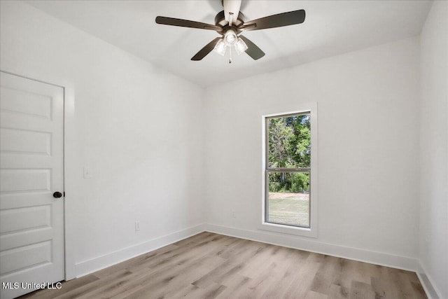 107 NE Adams Ave, Magee, MS 39111 - empty room with light wood finished floors, a ceiling fan, and baseboards