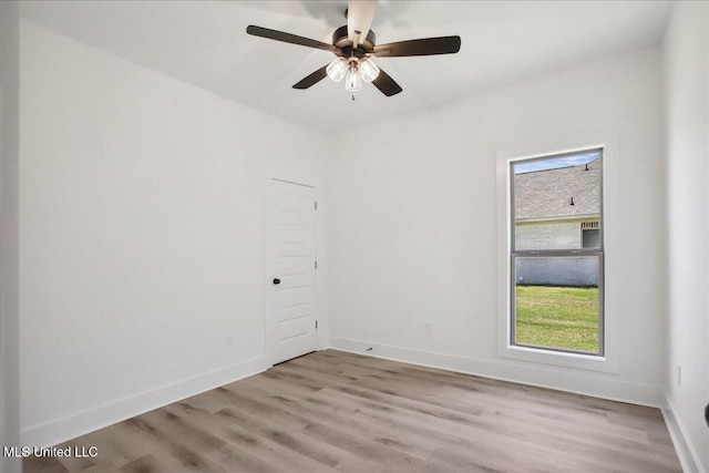107 NE Adams Ave, Magee, MS 39111 - empty room featuring light wood finished floors, plenty of natural light, and ceiling fan