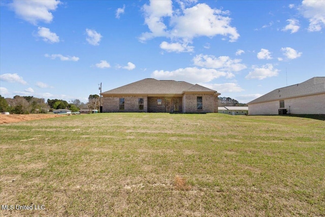 107 NE Adams Ave, Magee, MS 39111 - back of house featuring a yard and central AC
