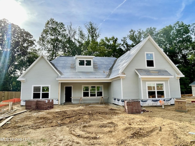 rear view of property featuring covered porch