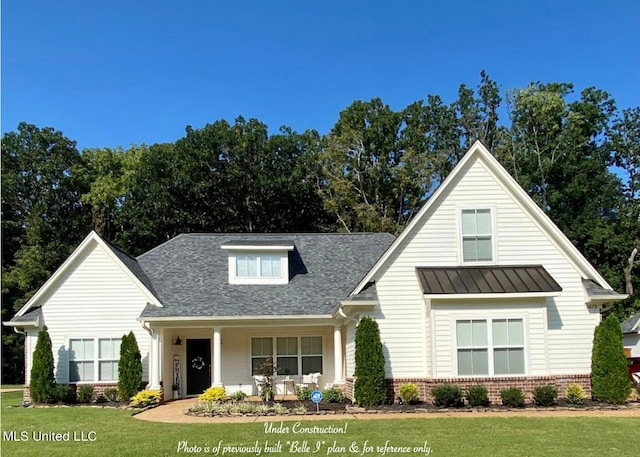 modern farmhouse with a porch and a front lawn