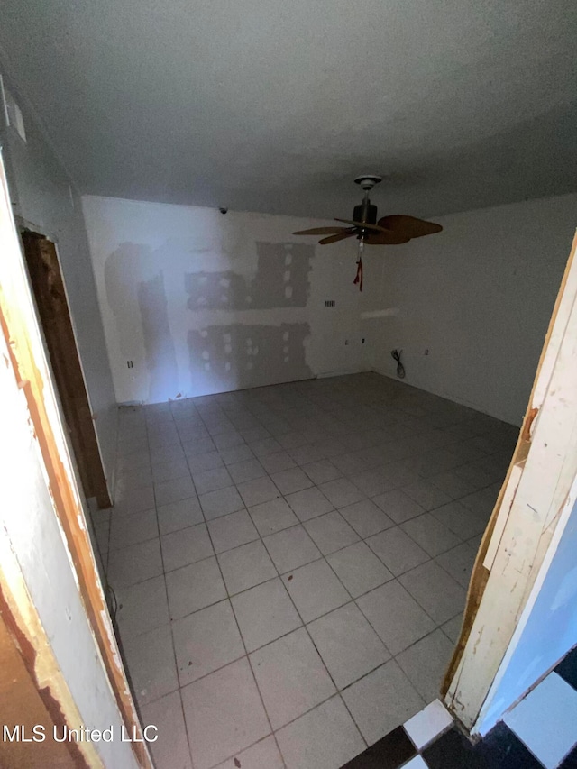 interior space featuring ceiling fan and light tile patterned floors