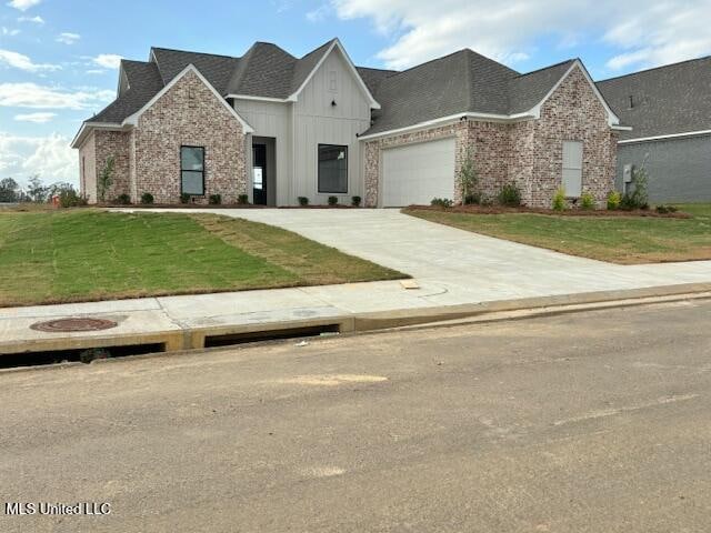 view of front of home featuring a garage and a front lawn