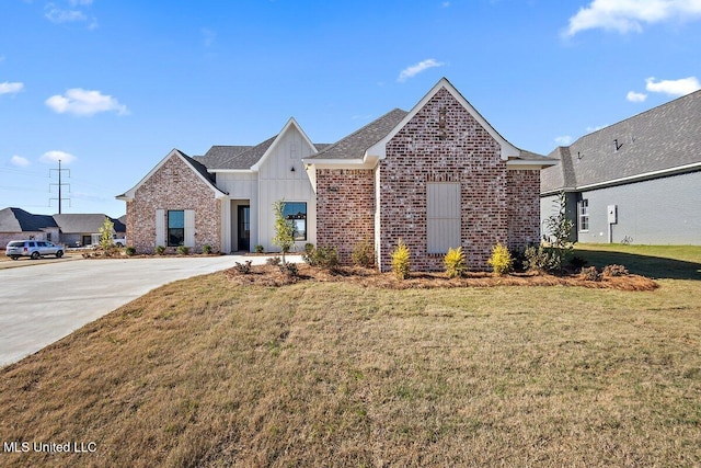 840 Glenwild Cir, Canton, MS 39046 - view of front facade featuring board and batten siding, brick siding, a front lawn, and a shingled roof