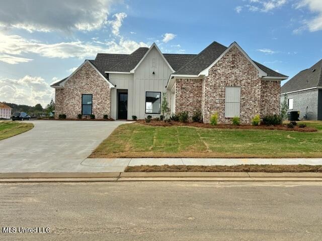 view of front of property with cooling unit and a front yard