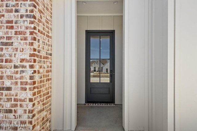 840 Glenwild Cir, Canton, MS 39046 - view of exterior entry featuring brick siding and board and batten siding