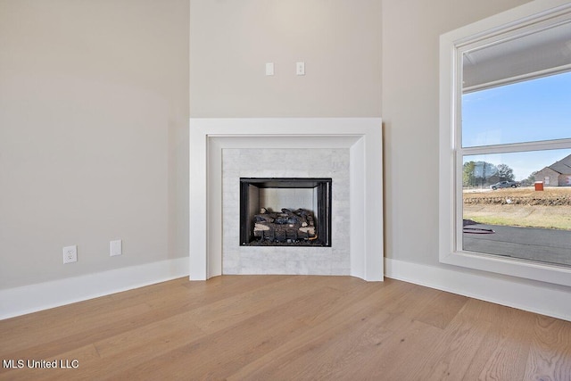 840 Glenwild Cir, Canton, MS 39046 - detailed view of wood finished floors, baseboards, and a tiled fireplace