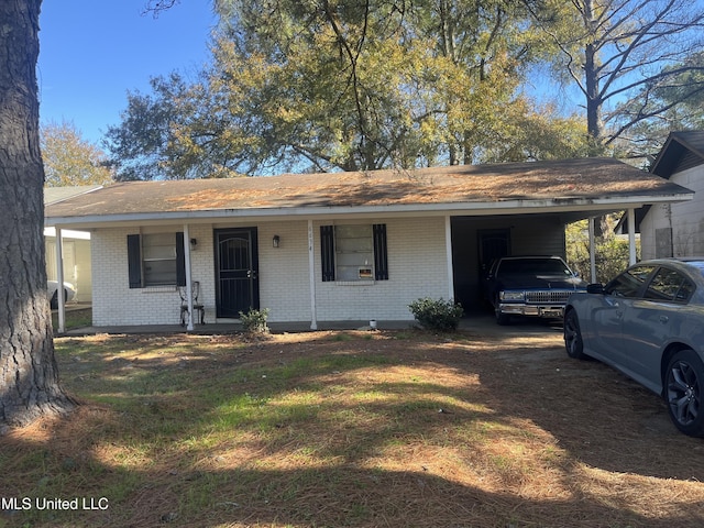 single story home featuring a porch and a carport