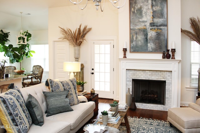 living area featuring a brick fireplace and wood finished floors