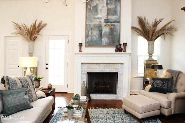 living room with a fireplace, plenty of natural light, and wood finished floors