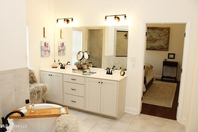 bathroom with double vanity, a sink, tile patterned flooring, a freestanding tub, and walk in shower