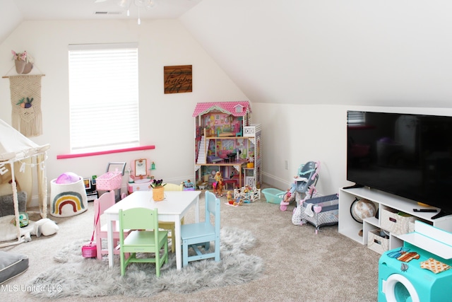 recreation room with carpet floors, visible vents, and vaulted ceiling