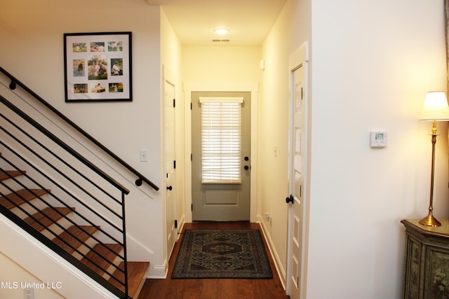 entryway featuring stairs, visible vents, and dark wood-style flooring