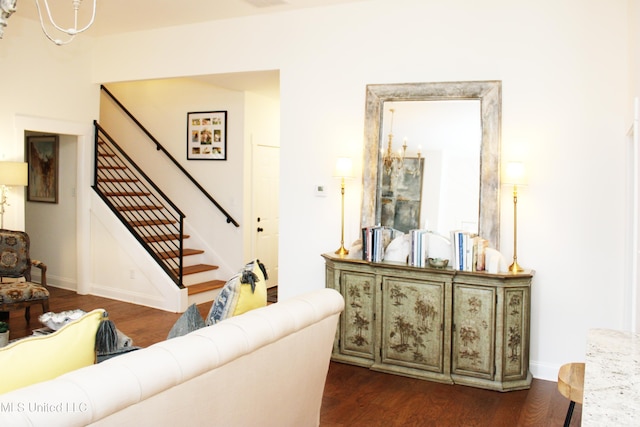 living area with baseboards, stairway, and dark wood-style flooring