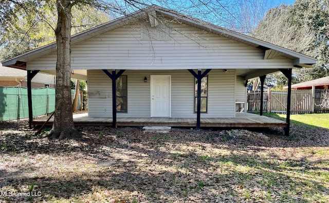 bungalow-style home with a porch and fence