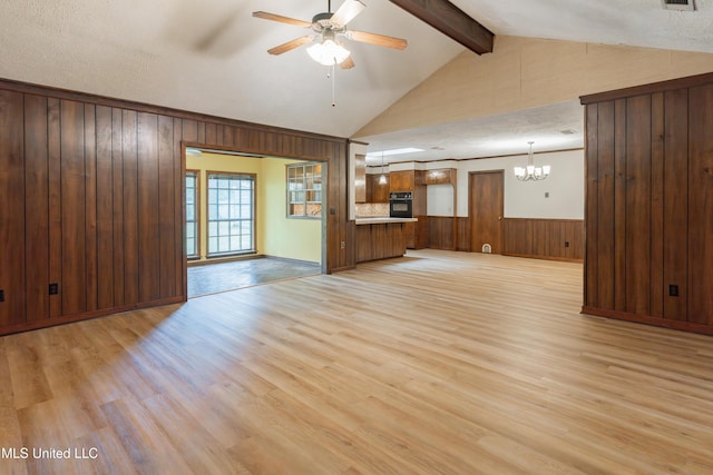 504 Hampton St, Clinton, MS 39056 - unfurnished living room featuring wood walls, light wood-style floors, a ceiling fan, a chandelier, and a wainscoted wall