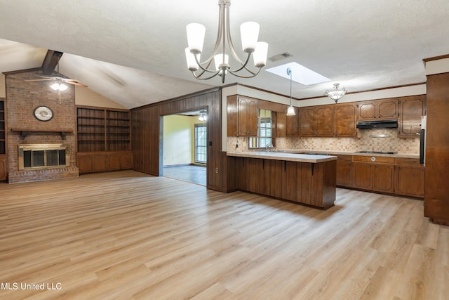 504 Hampton St, Clinton, MS 39056 - kitchen with open floor plan, ceiling fan, light wood-style floors, a peninsula, and wooden walls