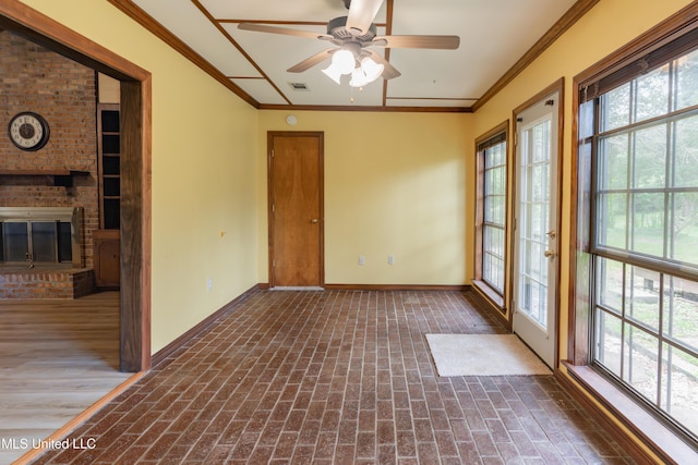 504 Hampton St, Clinton, MS 39056 - unfurnished room with crown molding, plenty of natural light, brick flooring, baseboards, and a ceiling fan