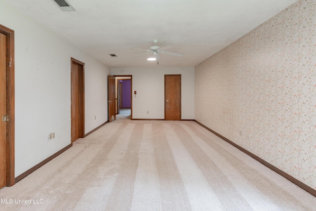 504 Hampton St, Clinton, MS 39056 - unfurnished room with wallpapered walls, ceiling fan, light carpet, and baseboards