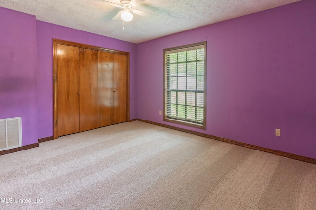 504 Hampton St, Clinton, MS 39056 - unfurnished bedroom featuring carpet floors, a textured ceiling, baseboards, and a closet