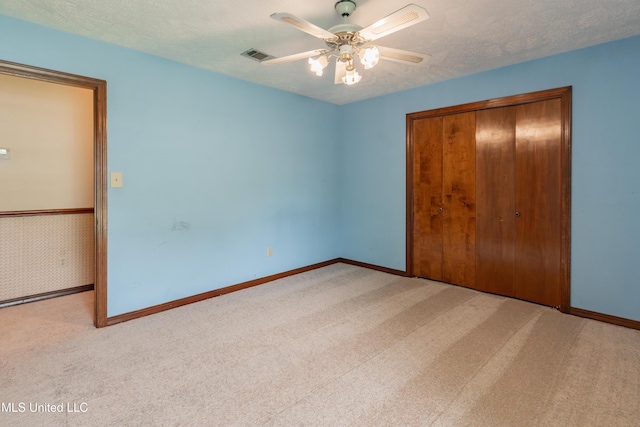 504 Hampton St, Clinton, MS 39056 - unfurnished bedroom with carpet floors, a closet, baseboards, a ceiling fan, and a textured ceiling