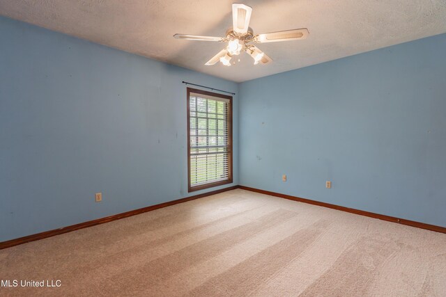 504 Hampton St, Clinton, MS 39056 - spare room with carpet floors, a textured ceiling, a ceiling fan, and baseboards
