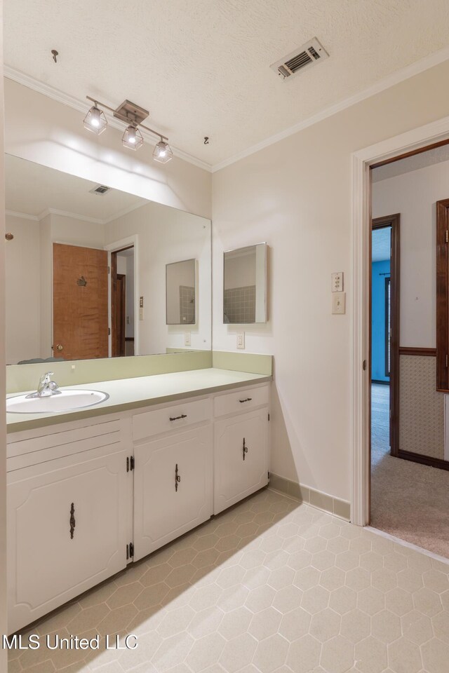 504 Hampton St, Clinton, MS 39056 - bathroom featuring crown molding, vanity, tile patterned flooring, and baseboards